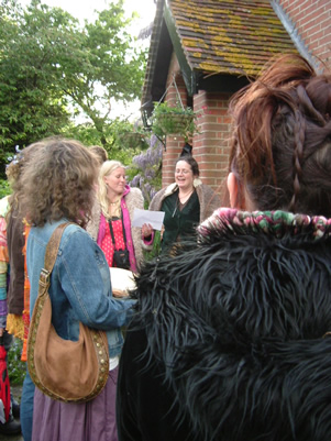 Kate teaching a chant at a handfasting.